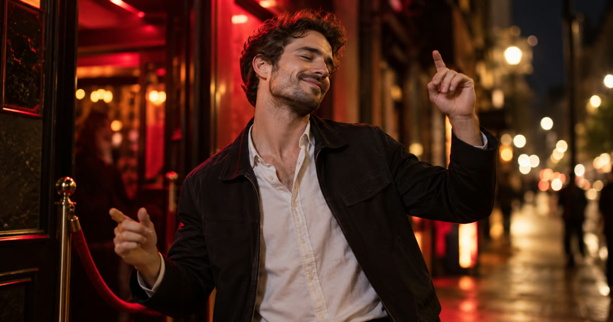 Man gesturing to music outside a red-lit doorway